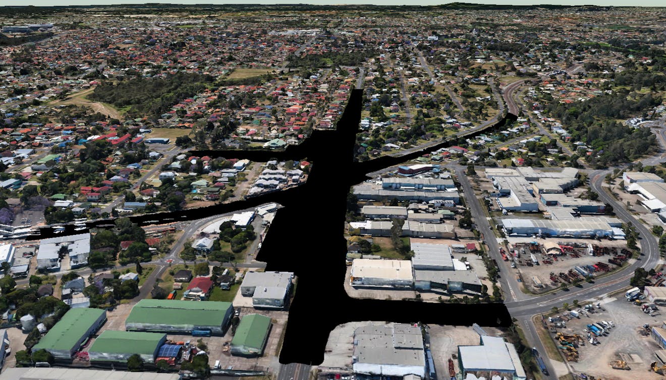 The design model footprint hidden from Google Photorealistic 3D Tiles in CesiumJS using a ClippingPolygon